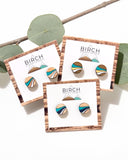 Round wood stud earrings with retro wave design.