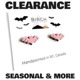 A promotional clearance graphic for Birch Tree Studio showing two small handpainted pink bat stud earrings on a white card with black bat silhouettes and the text 'CLEARANCE' and 'SEASONAL & MORE'.